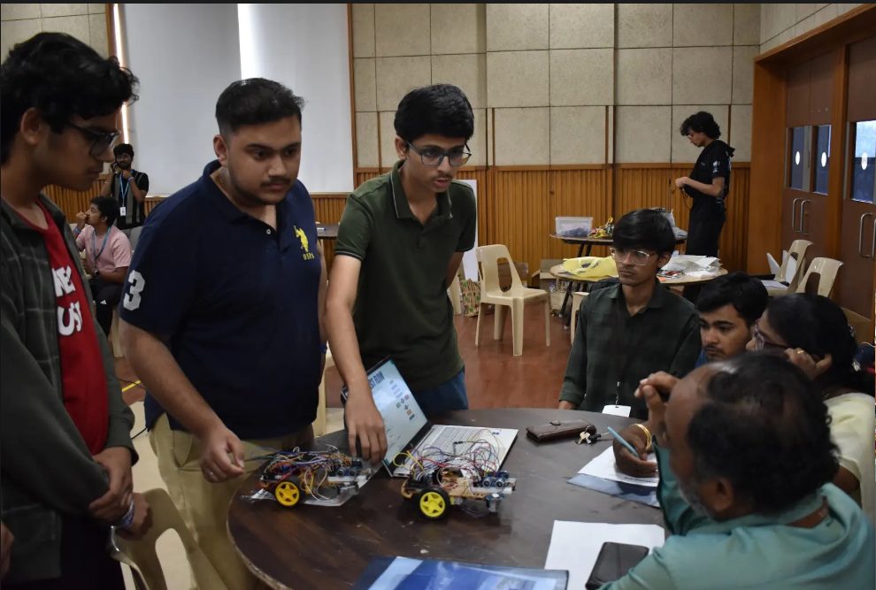 A team demonstrating robot car prototypes at Makeathon 2026